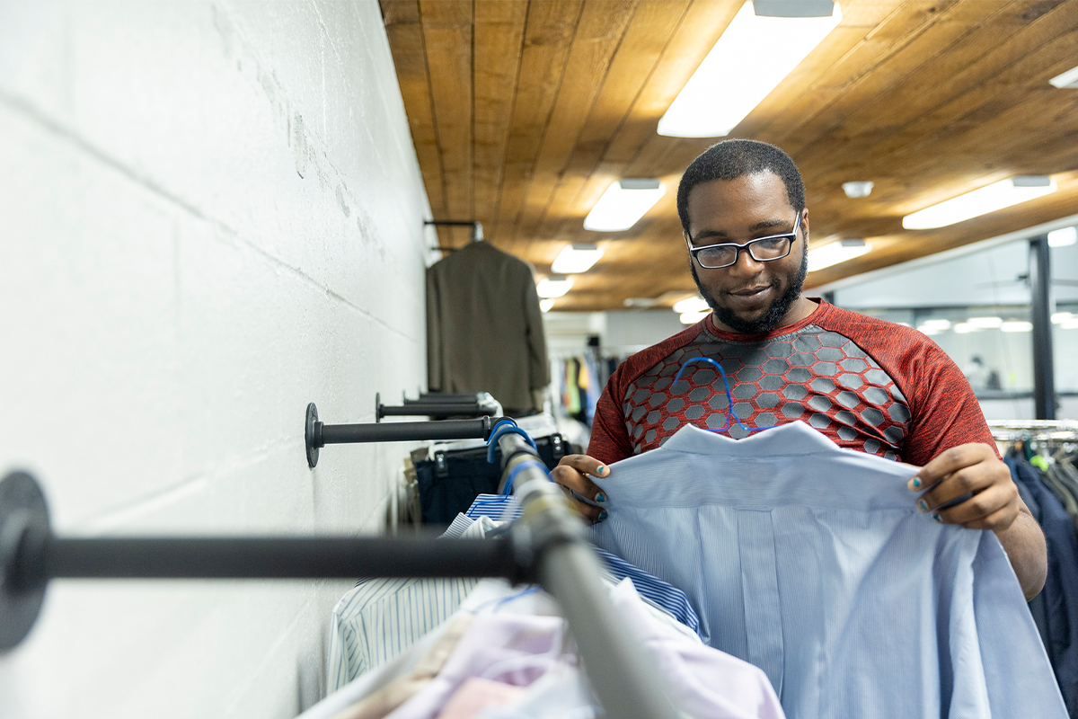 A student shopping for professional clothing from the Career Closet