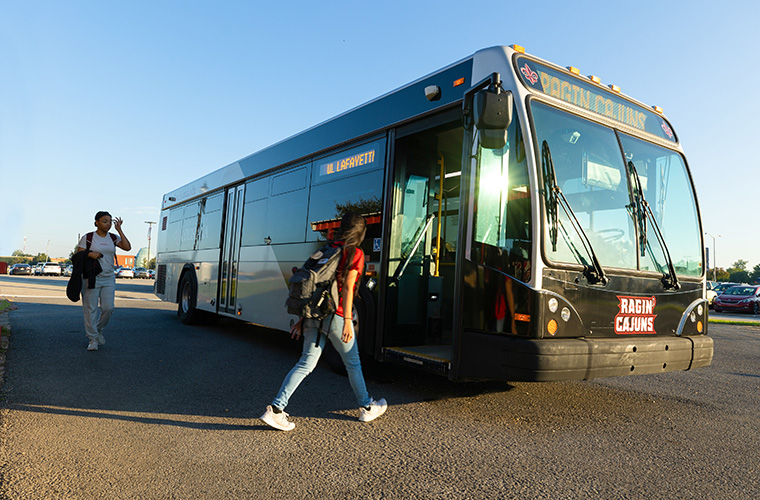 a UL Lafayette bus waits for students near Cajun Field