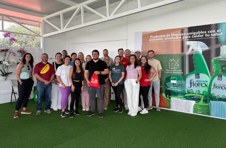 MBA students studying abroad in Costa Rica smile for a group photo at the Florex production facility they visited.