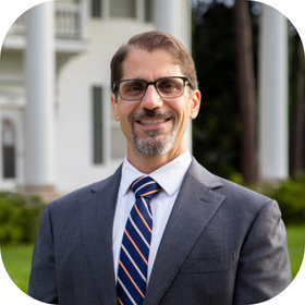 Asst. Director of Instructional Support Francesco Crocco pictured in front of UL Lafayette's Whittington House