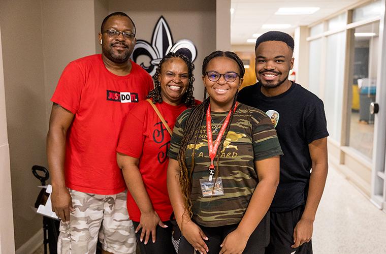 UL Lafayette studen tposes in her new dorm hall with her family on Move-In Day