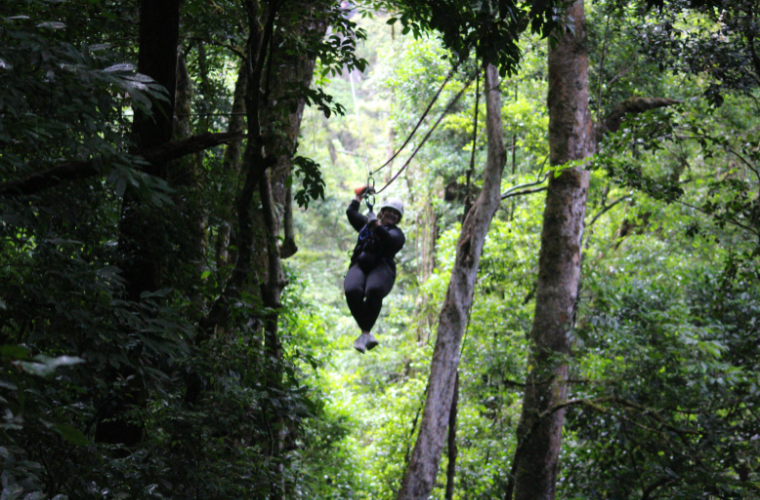 Amanda Devillier, online MBA student, ziplines through the Costa Rican rainforest while studying abroad.