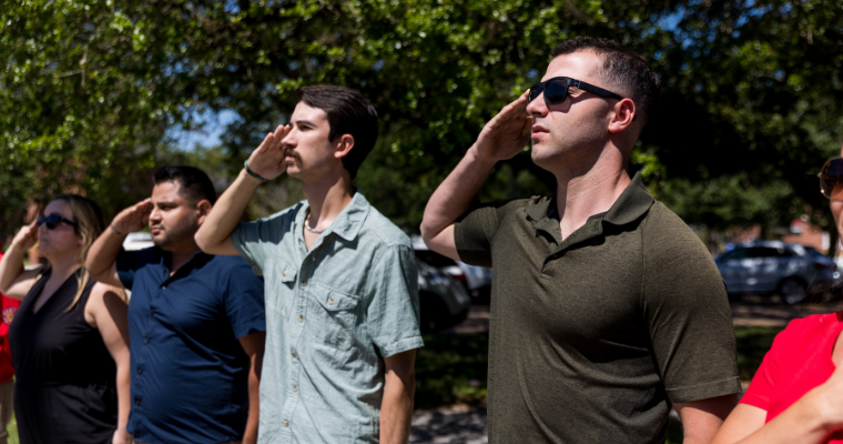 Online student veteran salutes the flag as part of the student veteran organization. 