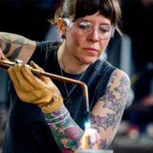 Metalwork and jewelry professor Anne Buhold using a blowtorch.