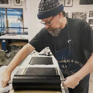 Photo of Brian Kelly printmaking.