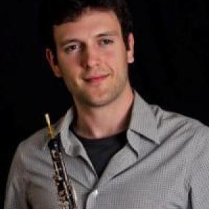 Portrait photo of Brennan Guidry holding an instrument.