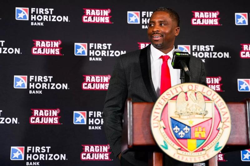 Men's basketball coach Quannas White speaks at a press conference.